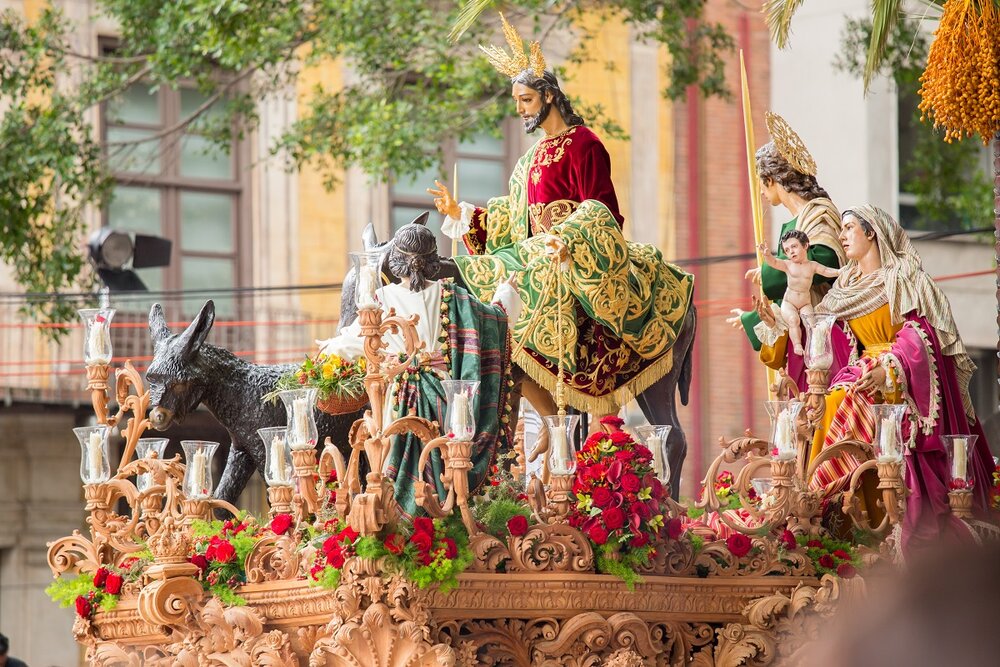 Holy Week procession in Spain depicting colourful religious figures