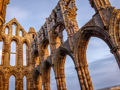 Sunset view of Whitby abbey overlooking the North Sea on the East Cliff above Whitby in North Yorkshire, England, UK
