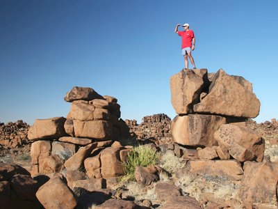 Man standing on rock, Namibia, South Africa