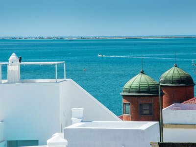 Cubic rooftops with light blue sea in distance, Olhao, Portugal