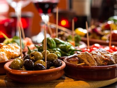 Close up of tapas meal divided in dishes placed on table