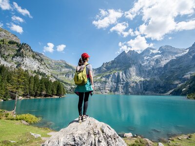 Young woman hiker near Oeschinensee (Oeschinen Lake) in summer, Kandersteg, Switzerland
