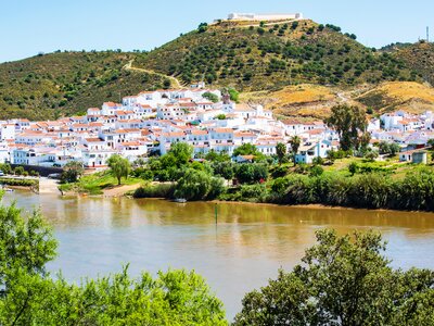 Alcoutim nestled in hillside by river, Portugal