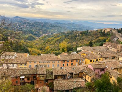 Landscape of Perugia with colourful buildings in foreground, Italy