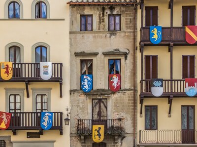 Medieval shields decorated over building balconies, Piazza Grande, Arezzo, Italy