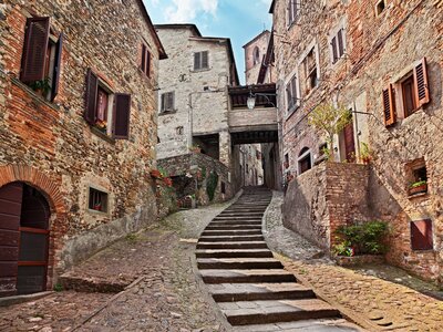 Narrow alley with staircase in medieval village Anghiari, Arezzo, Tuscany, Italy