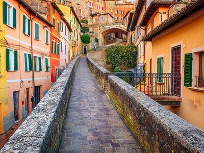 Colourful buildings of medieval aqueduct street in the morning, Perugia, Italy