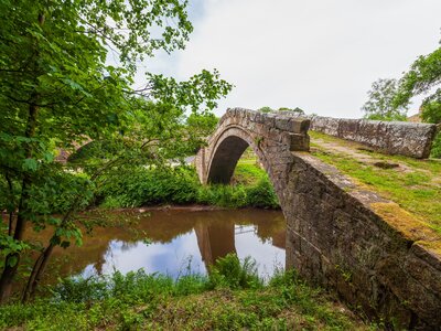 Medieval packhorse single arch Beggar’s bridge above river Esk, Glaisdale, Yorkshire