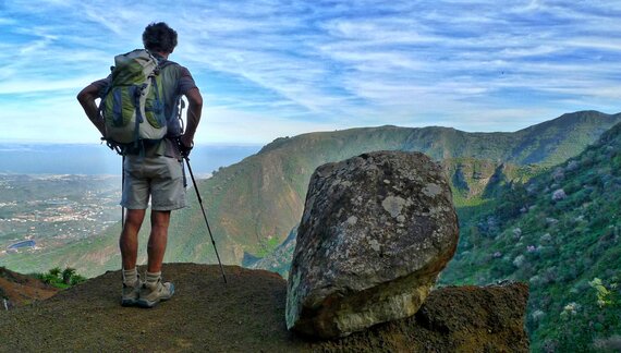 Ramble Worldwide member of walking holiday group male hiker enjoying view of mountainous landscape in Gran Canaria North Coast, Canary Islands, Spain